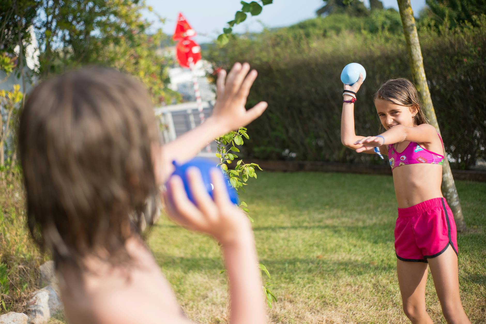 Beat the Heat: 20 Refreshing Ideas to Stay Cool This Summer 2 woman in red tank top holding blue ball